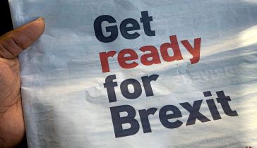 Hand holding newspaper that reads GET READY FOR BREXIT